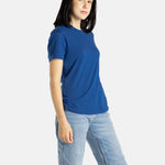 Sophia (A woman with long black hair) wears the No Limbits Adaptive Women's Navy Sensory Tee.