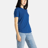 Sophia (A woman with long black hair) wears the No Limbits Adaptive Women's Navy Sensory Tee.