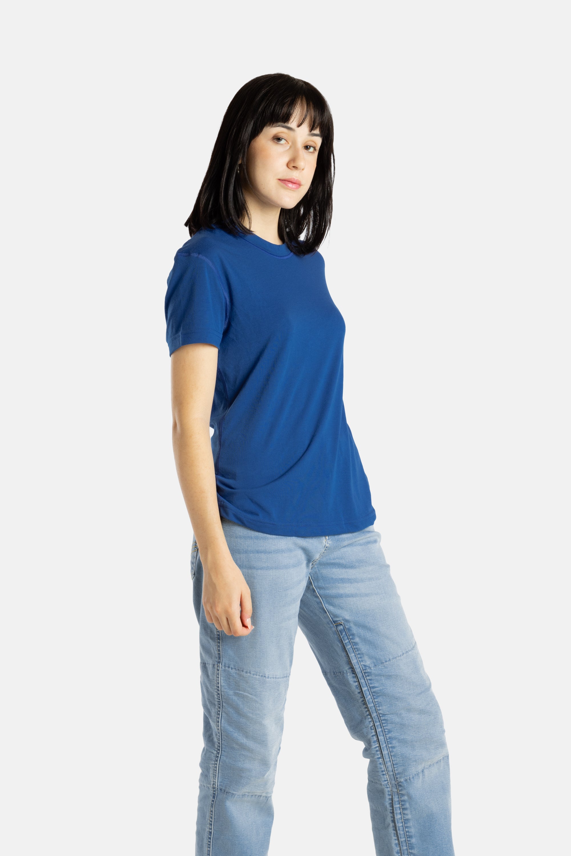 Sophia (A woman with long black hair) wears the No Limbits Adaptive Women's Navy Sensory Tee.