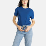 Sophia (A woman with long black hair) wears the No Limbits Adaptive Women's Navy Sensory Tee.