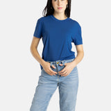 Sophia (A woman with long black hair) wears the No Limbits Adaptive Women's Navy Sensory Tee.