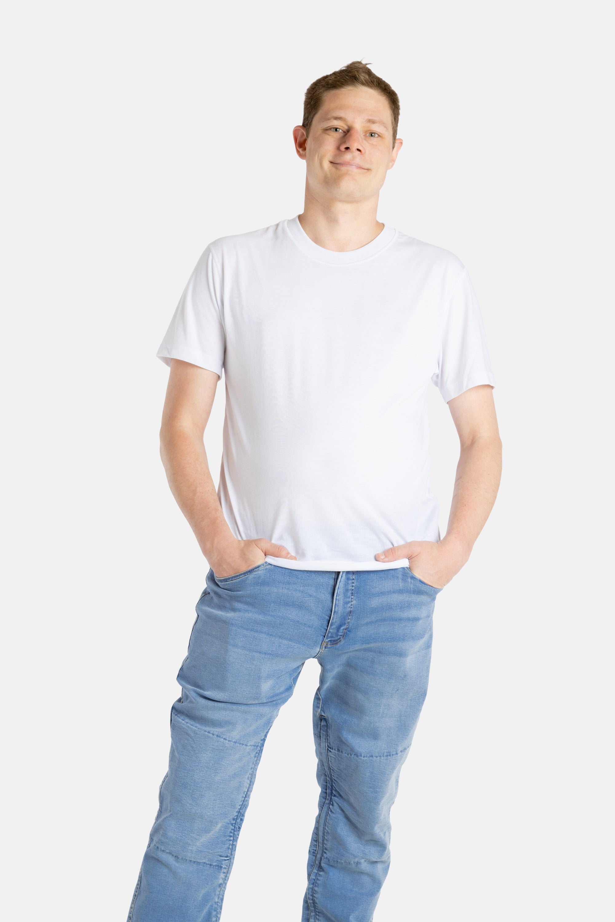 A white man with short brown hair wears a white t-shirt.