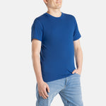 A white man with short brown hair wears a navy t-shirt.
