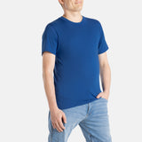 A white man with short brown hair wears a navy t-shirt.