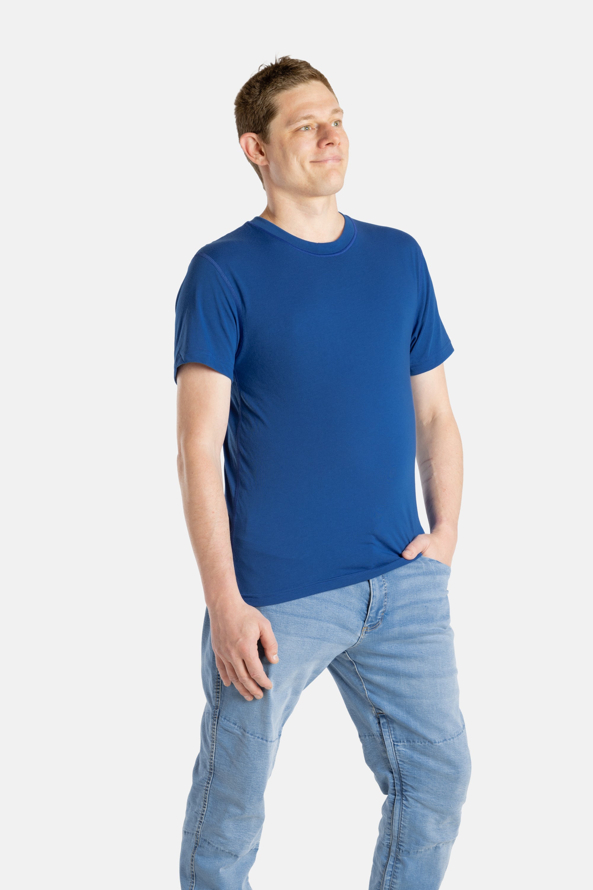 A white man with short brown hair wears a navy t-shirt.