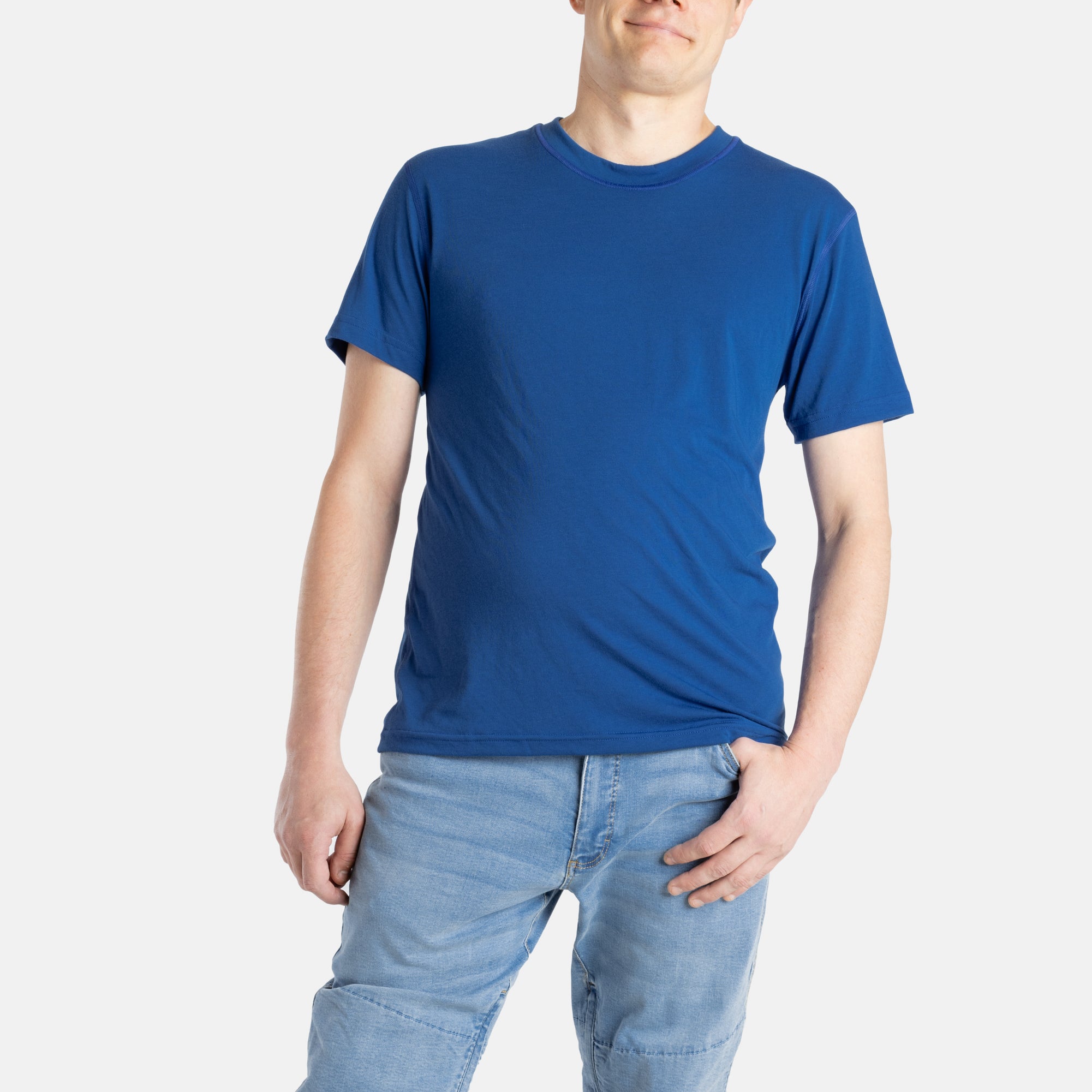 A white man with short brown hair wears a navy t-shirt.