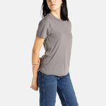 Sophia (A woman with long black hair) wears the No Limbits Adaptive Women's Charcoal Sensory Tee.