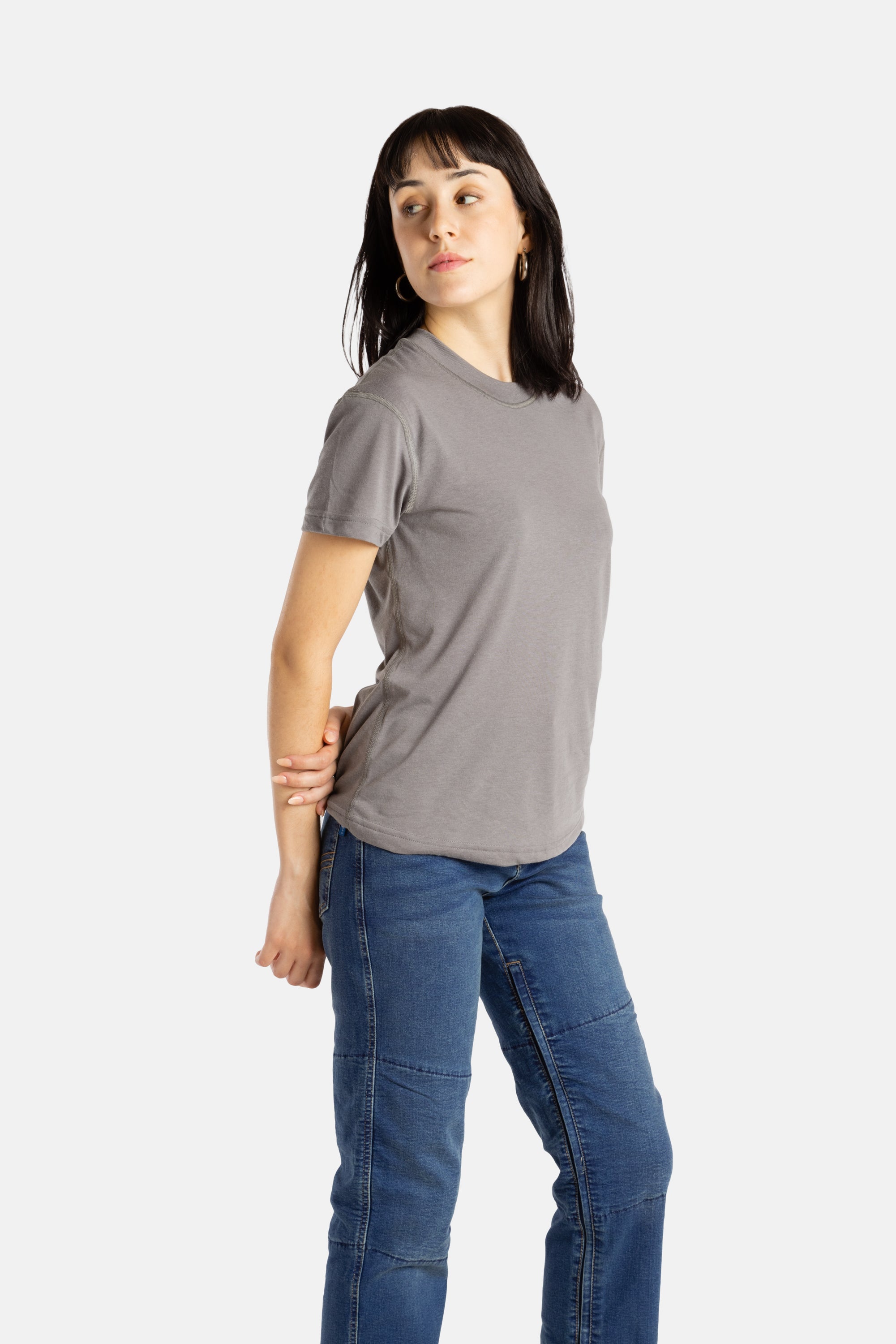 Sophia (A woman with long black hair) wears the No Limbits Adaptive Women's Charcoal Sensory Tee.