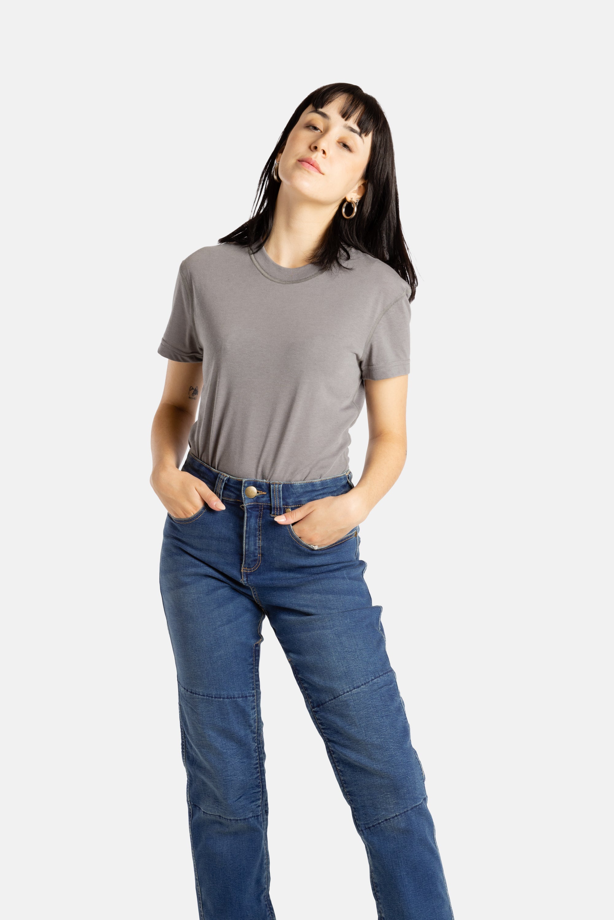 Sophia (A woman with long black hair) wears the No Limbits Adaptive Women's Charcoal Sensory Tee.