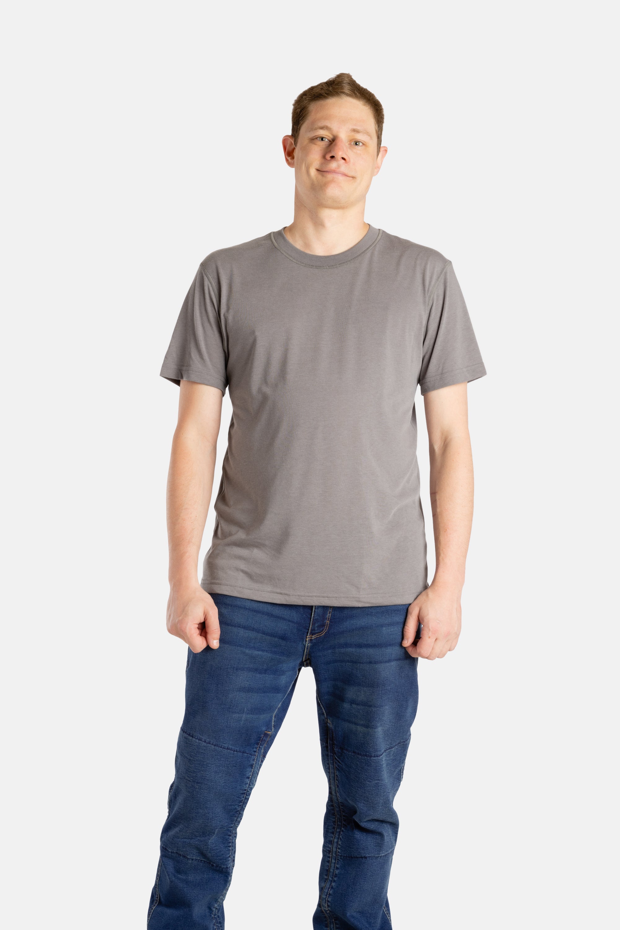 A white man with short brown hair wears a charcoal t-shirt.