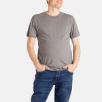 A white man with short brown hair wears a charcoal t-shirt.