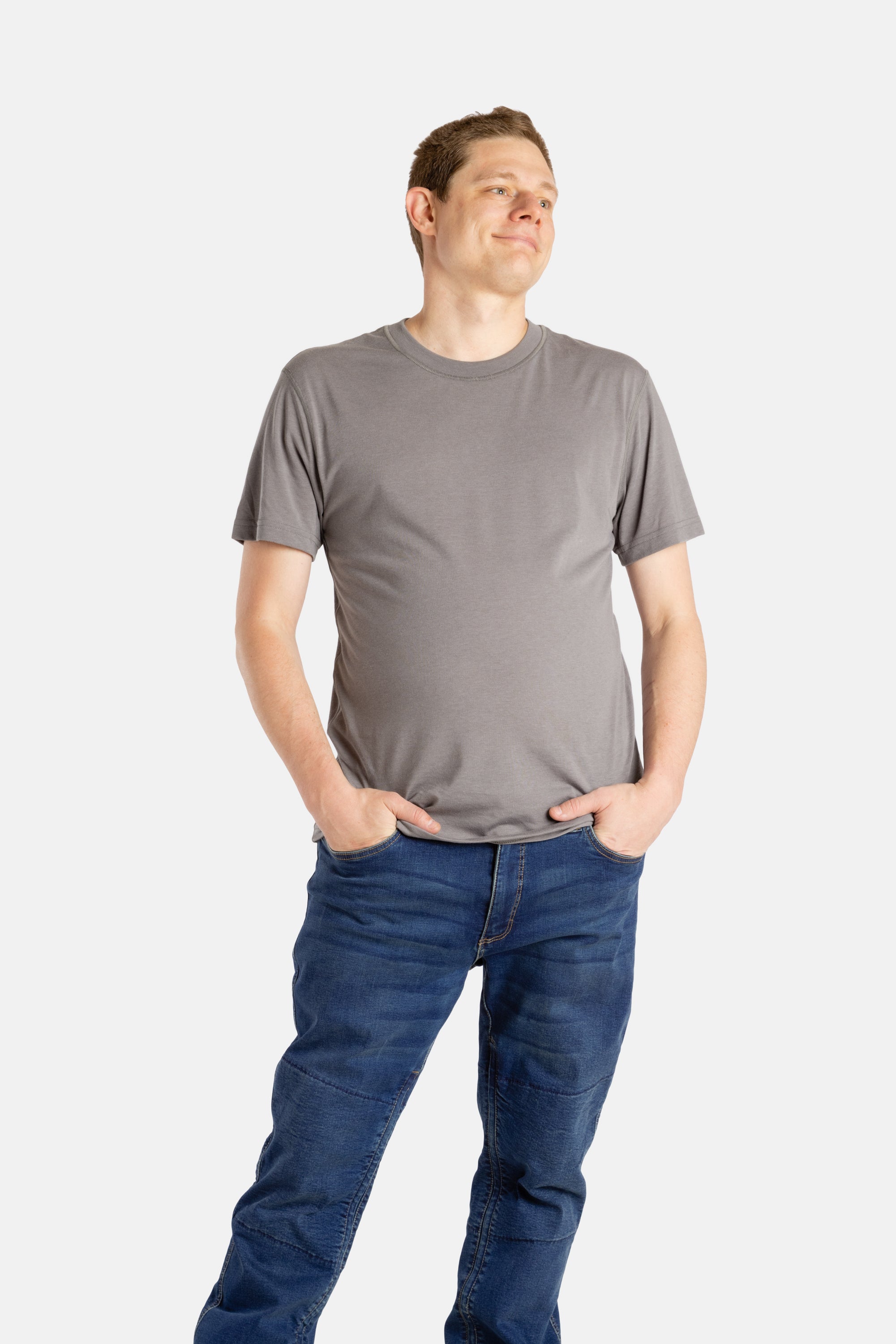 A white man with short brown hair wears a charcoal t-shirt.