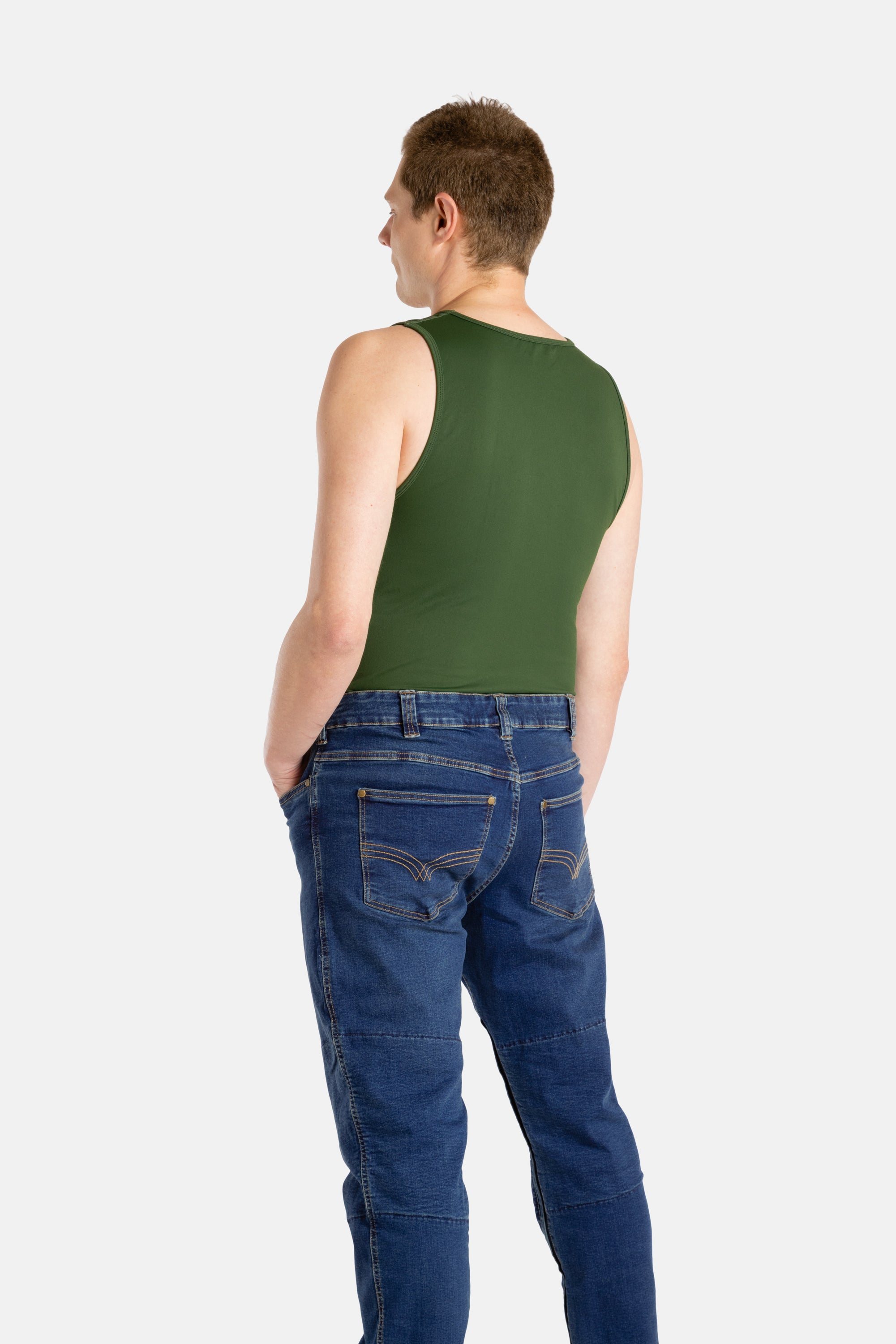 The back of a white man with short brown hair wearing an olive-green tank top and denim jeans.