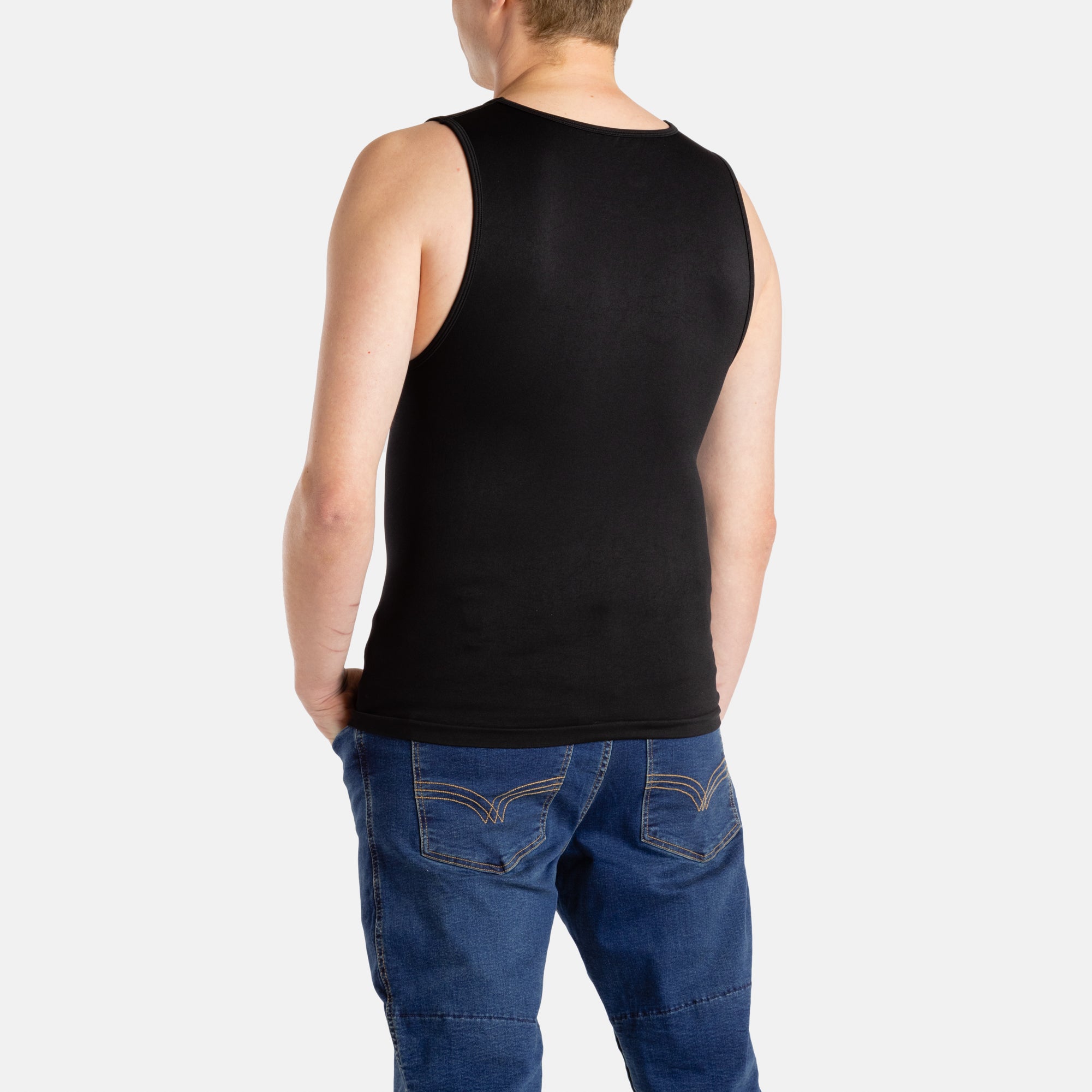 The back of a white man with short brown hair wearing a black tank top and denim jeans.