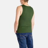 The back of a white man with short brown hair wearing an olive-green tank top and denim jeans.