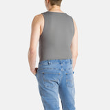 A white man with short brown hair wearing a charcoal-gray tank top and denim jeans.