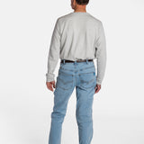 The back of a white, elderly man with a mustache wearing the Men’s Light Wash Unlimbited Pants, with a long-sleeved gray shirt, a brown belt, and brown shoes.