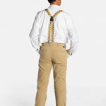 The back of a white, elderly man with a mustache wearing the No Limbits Adaptive Men's Khaki Unlimbited Pants, with a white shirt, tan suspenders, and brown shoes.