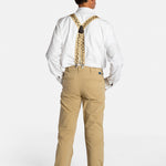 The back of a white, elderly man with a mustache wearing the No Limbits Adaptive Men's Khaki Unlimbited Pants, with a white shirt, tan suspenders, and brown shoes. 