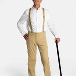 A white, elderly man with a mustache wears the No Limbits Adaptive Men's Khaki Unlimbited Pants with a white shirt, tan suspenders, a matching hat, and brown shoes. He poses with his black cane.