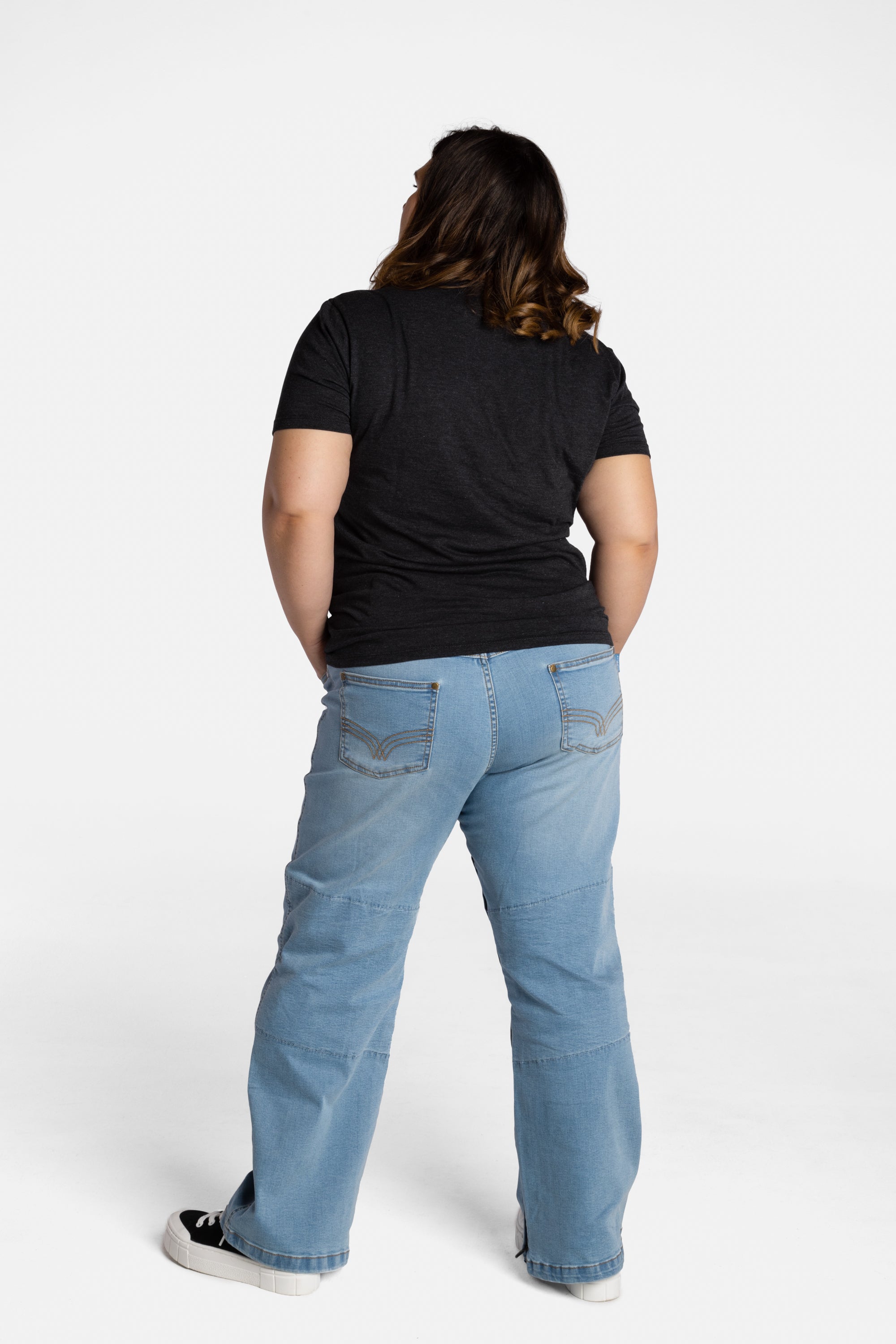 The back of Erica Cole, the founder of No Limbits, wearing the No Limbits Adaptive Women's Light Wash Unlimbited Pants.