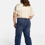 The back of Erica Cole, the founder of No Limbits, wearing the No Limbits Adaptive Women's Dark Wash Unlimbited Pants.