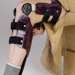 The zipper of the  No Limbits Adaptive Men's Khaki Unlimbited Pants is zipped up to reveal a knee brace on the wearer.