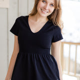A white woman with long blonde hair is wearing the No Limbits Adaptive Women's Black Sensory Blouse.