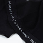 A seam of the shirt has gray words that say "You Matter - Sky's the Limbit - Not All Disabilities are Visual."