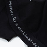 A seam of the shirt has gray words that say "You Matter - Sky's the Limbit - Not All Disabilities are Visual."