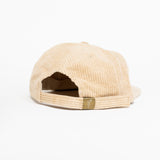 The back of a cream baseball cap with brown text that says "disability is not a bad word."