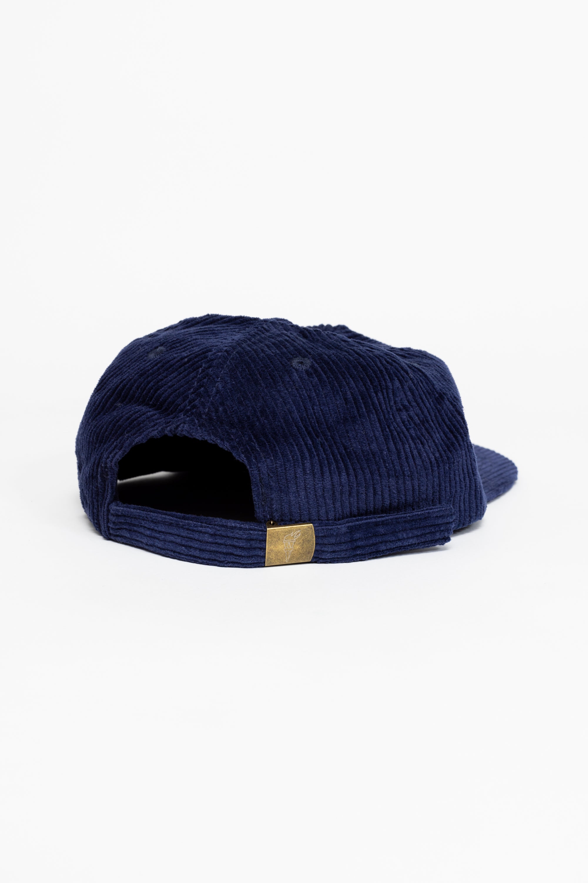 The back of a dark blue baseball cap that has a illustration of the moon and the stars that says in white font "Sky's the Limbit."