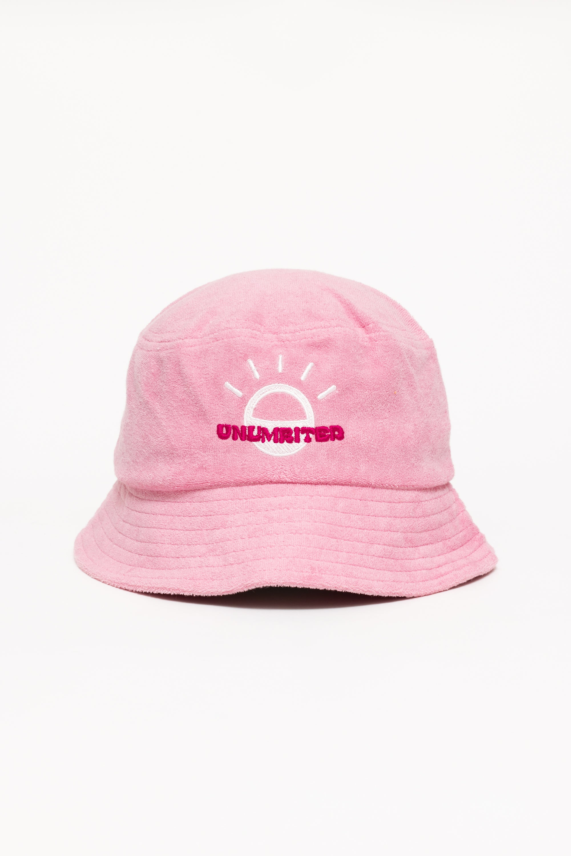 A light pink bucket hat with a white illustration of the sun and pink text that says "Unlimbited"