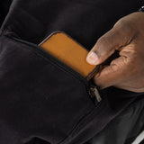 The user takes out their wallet from the pocket.