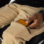 The user takes out their wallet from the pocket.