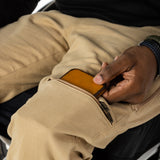 The user takes out their wallet from the pocket.