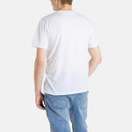 The back of a white man with short brown hair wearing a white t-shirt.