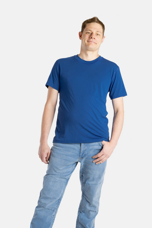 A white man with short brown hair wears a navy t-shirt.