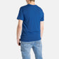 The back of a white man with short brown hair wearing a navy t-shirt.