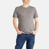 A white man with short brown hair wears a charcoal t-shirt.