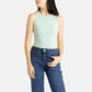A white woman with long black hair and hoop earrings wears a sea form (Very light green) tank top and denim jeans.