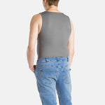 A white man with short brown hair wearing a charcoal-gray tank top and denim jeans.