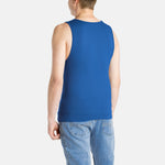 The back of a white man with short brown hair wearing a navy tank top and denim jeans.
