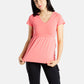 Sophia (A woman with long black hair) is wearing the No Limbits Adaptive Women's Coral Sensory Blouse with black leggings.