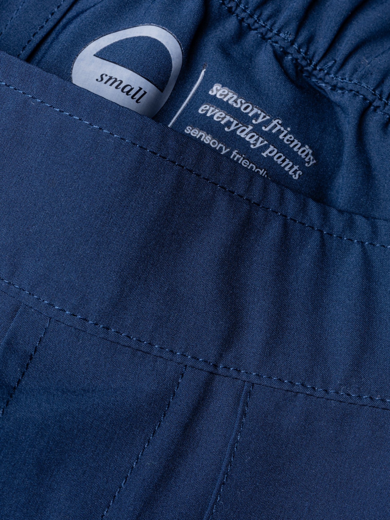Close-up image of sensory friendly waistband. Both interior and exterior seams are flat. 