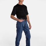 A white, elderly man with a mustache wears the No Limbits Adaptive Men's Dark Wash Unlimbited Pants (which looks like denim jeans), with a black shirt, a brown belt, and brown shoes.