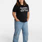 Erica Cole, the founder of No Limbits, wears the No Limbits Adaptive Women's Light Wash Unlimbited Pants. She's wearing the black "disability is not a bad word" T-shirt.
