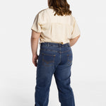 The back of Erica Cole, the founder of No Limbits, wearing the No Limbits Adaptive Women's Dark Wash Unlimbited Pants.