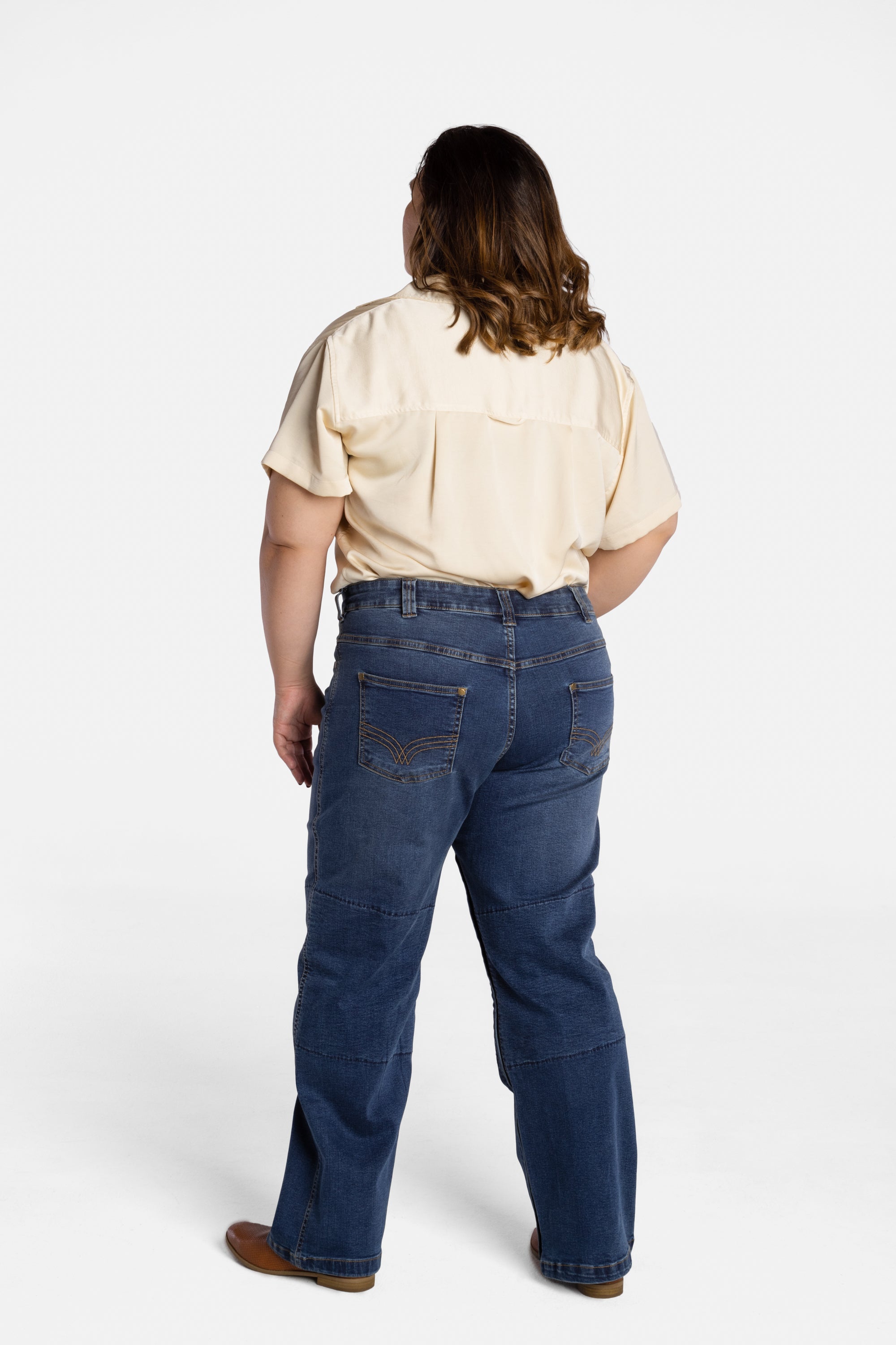 The back of Erica Cole, the founder of No Limbits, wearing the No Limbits Adaptive Women's Dark Wash Unlimbited Pants.