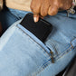 The user takes out their phone from the pocket.